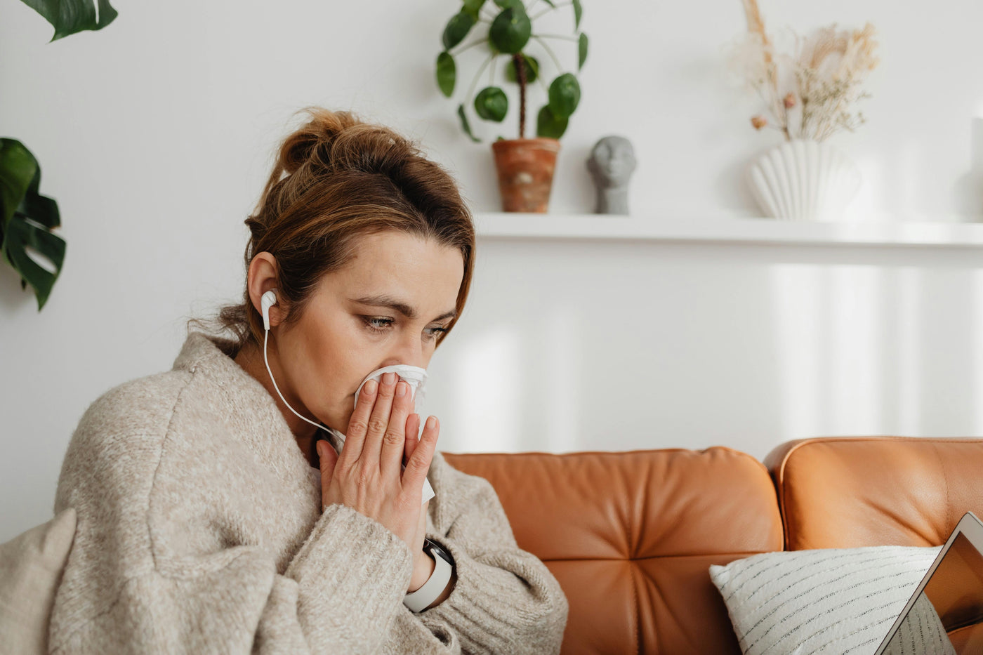 Person blowing their nose with hay fever, the kind of allergy spirulina has been studied to ease